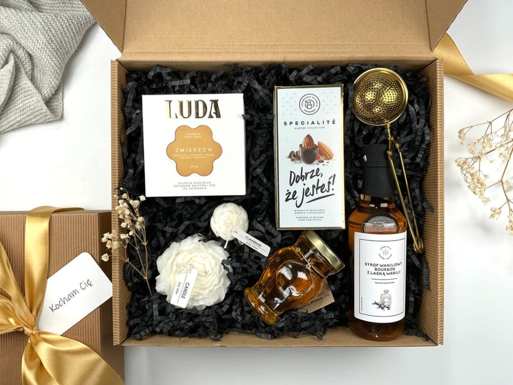 gotowy zestaw box prezentowy firmowy na urodziny imieniny a w nim herbata kwiatowa, migdały w ciemnej belgijskiej czekoladzie złoty zaparzacz do herbaty świece sojowe kwiat piwonii syrop waniliowy bourbon