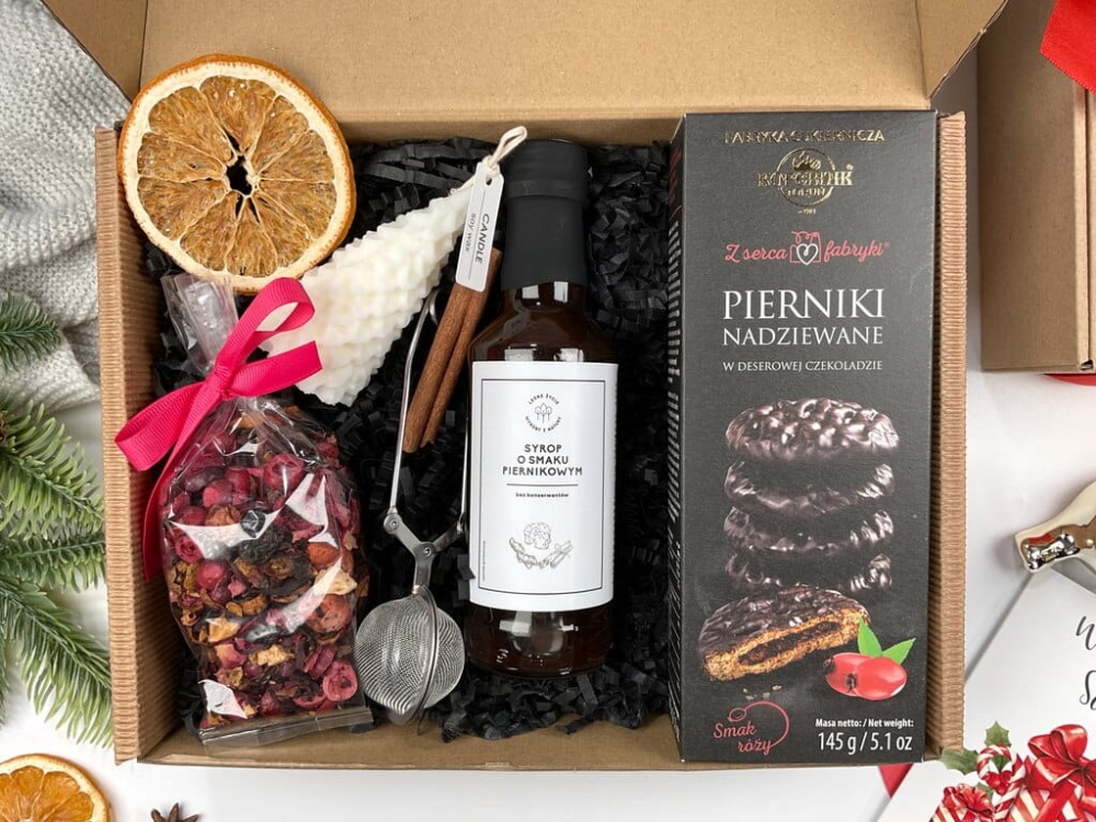 Zestaw bożonarodzeniowy z herbatą żurawinową, świecą sojową choinka, zaparzaczem, pierniczkami nadziewanymi różą i syropem piernikowym. Idealny prezent dla bliskich i współpracowników.