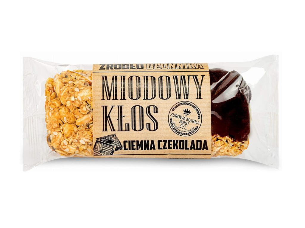 Naturalny baton miodowy Kłos z ciemną czekoladą. Chrupiąca pełnoziarnista przekąska, naturalne składniki, miód i błonnik pokarmowy. Idealny dla osób aktywnych i dbających o zdrową dietę.