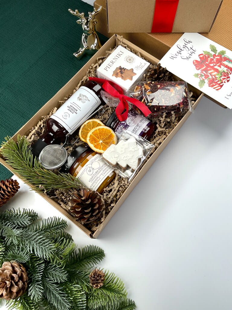 Elegancki box świąteczny: syrop red berries do grzańca, zimowa herbata żurawinowa, lukrowany pierniczek, konfitura pigwowa, krem miodowy i zaparzacz sitkowy. Doskonały prezent na święta i Mikołajki.