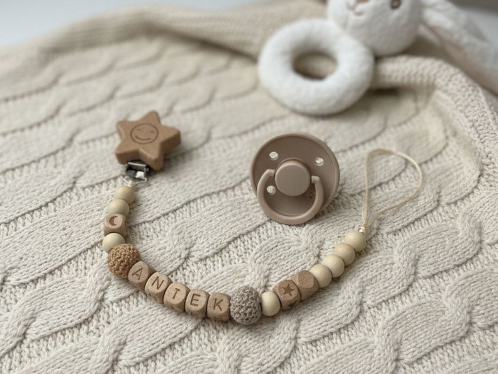 Ręcznie robiona, personalizowana zawieszka do smoczka z koralików drewnianych. Bezpieczna dla dziecka, modna i praktyczna – idealna na prezent z okazji narodzin.