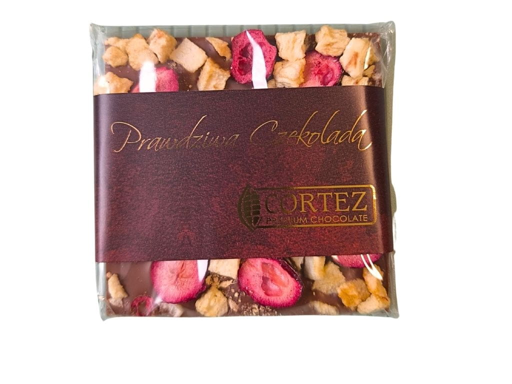 Ręcznie robiona czekolada mleczna z suszonymi jabłkami, żurawiną i imbirem. Kolorowa tabliczka rzemieślnicza o korzennym aromacie, idealna na prezent.